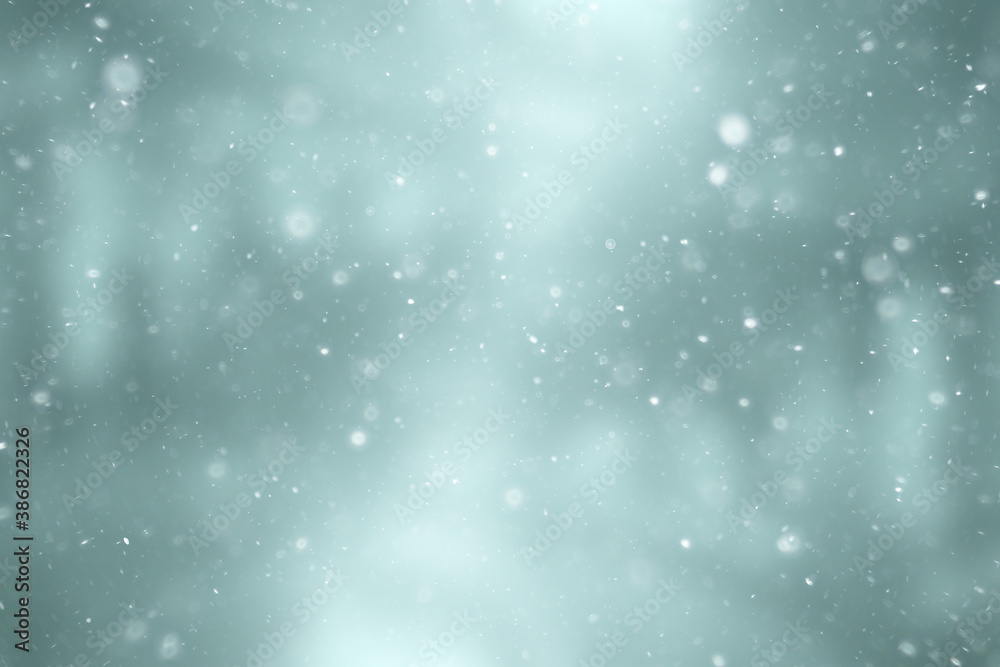 blurred snow / winter abstract background, snowflakes on abstract blurred glowing leaf background