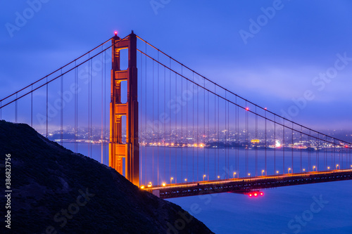Golden gate with blue overcast sky at dawn.