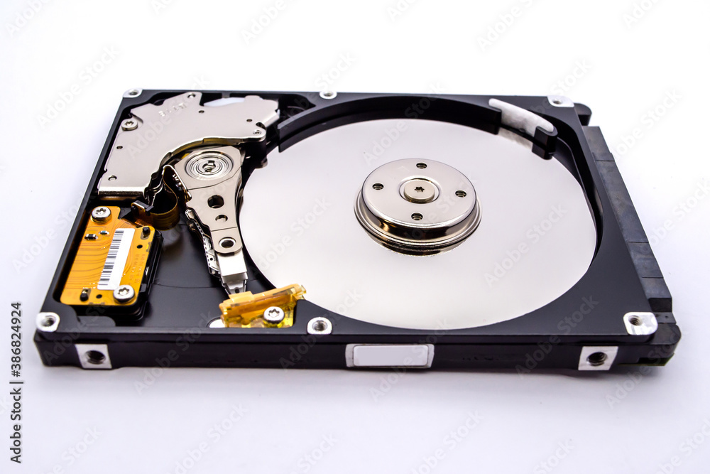 Internal parts of a hard disk isolated on a white background. Close up of Hard disk drive inside view. Internal parts of a hard disk isolated on a white background. Close up of Hard disk drive inside view.