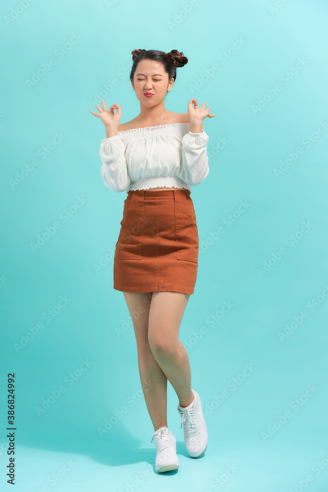 Happy emotional teen girl wearing t-shirt, jumping looking to side surprised in full length Happy emotional teen girl wearing t-shirt, jumping looking to side surprised in full length