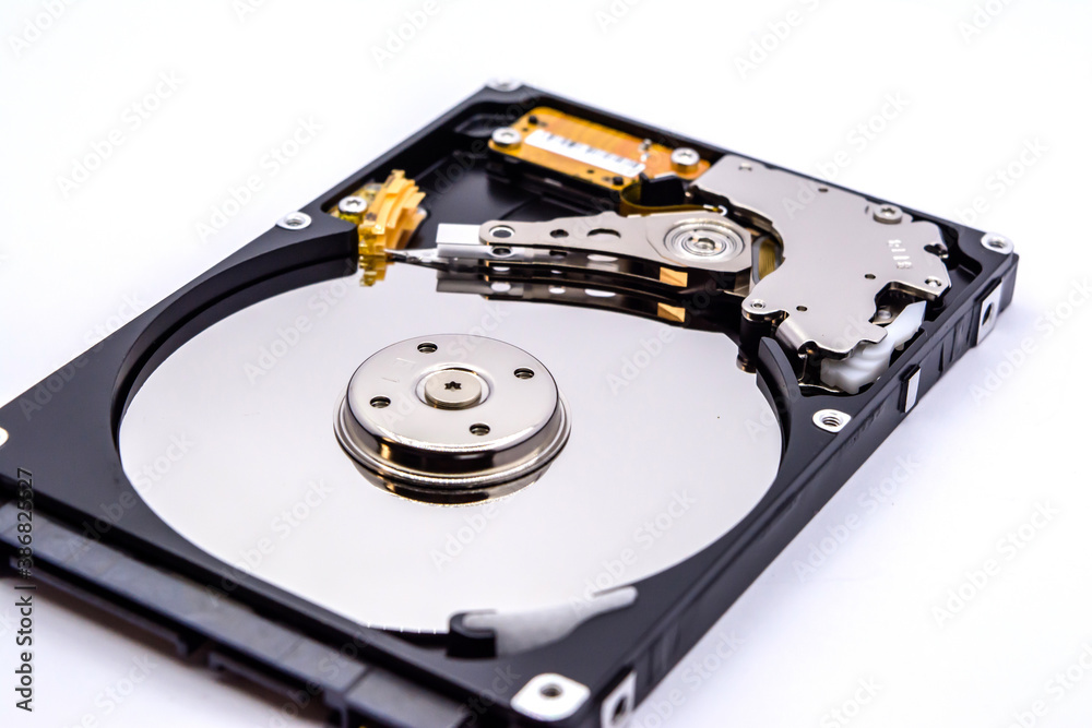 Internal parts of a hard disk isolated on a white background. Close up of Hard disk drive inside view. Internal parts of a hard disk isolated on a white background. Close up of Hard disk drive inside view.