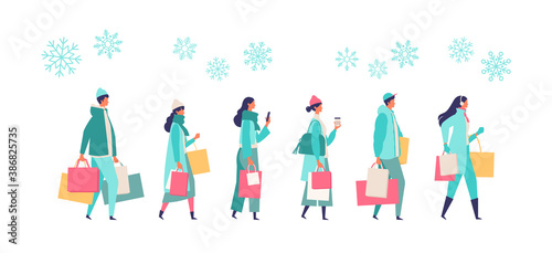 People carrying shopping bags at winter. Man and woman taking part in seasonal sale at store, shop, mall.