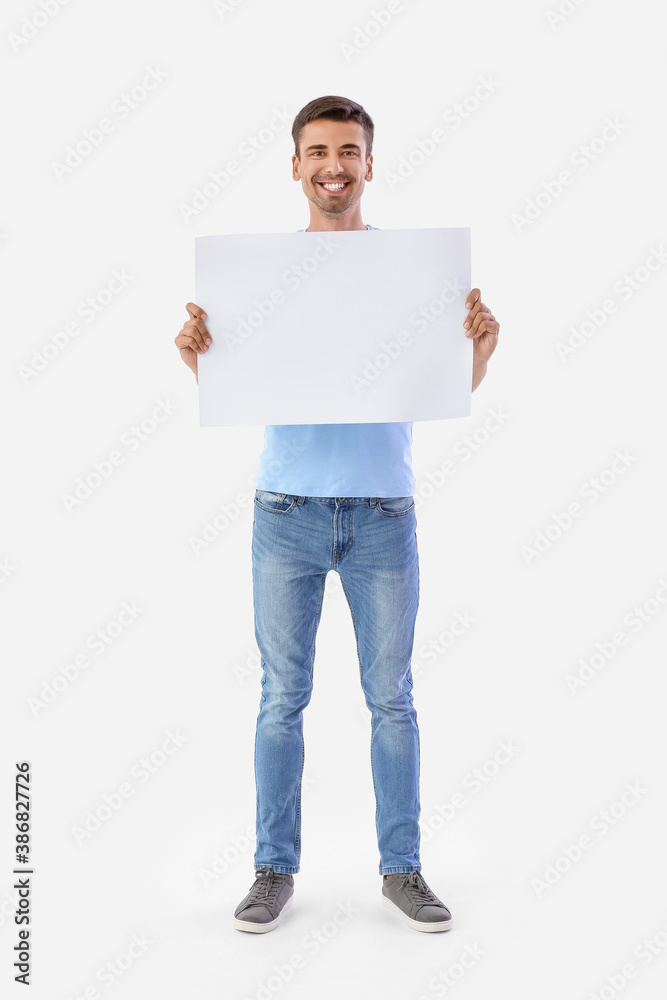 Young man with blank paper sheet on white background Young man with blank paper sheet on white background