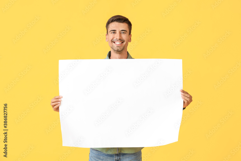 Young man with blank paper sheet on color background Young man with blank paper sheet on color background