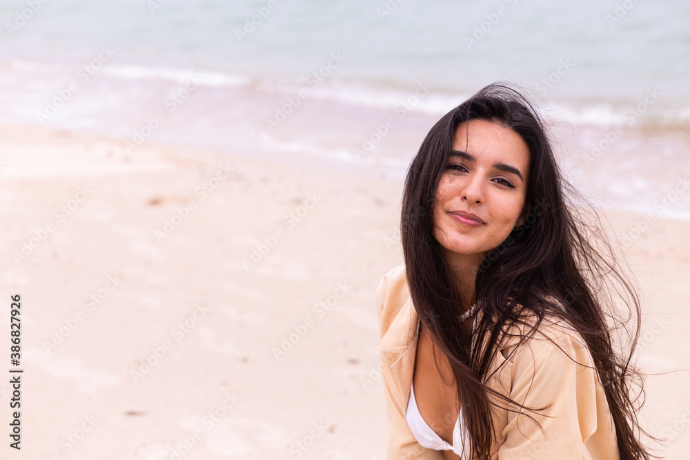 Romantic portrait of woman on beach at windy day, sunset warm light. Romantic portrait of woman on beach at windy day, sunset warm light.