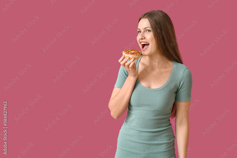 Beautiful young woman with sweet donut on color background Beautiful young woman with sweet donut on color background