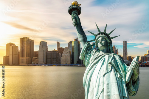 The Statue of Liberty over the Scene of New york cityscape river side which location is lower manhattan at the sunset time, Architecture and building with tourist concept