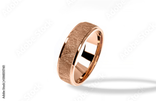 Golden wedding ring on a white background.