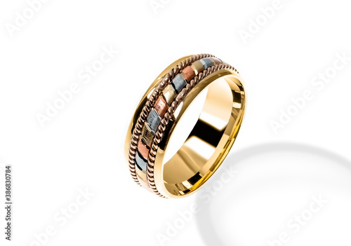 Golden wedding ring on a white background.