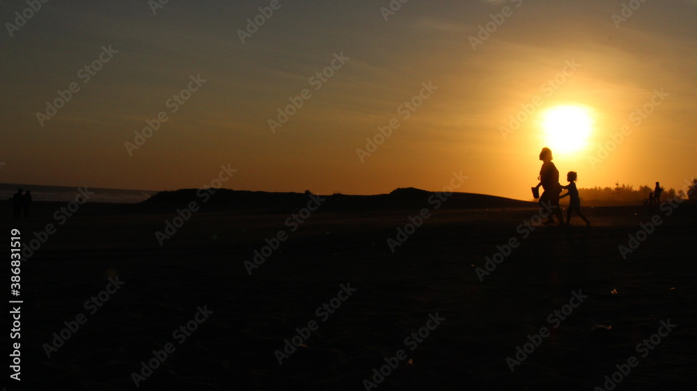 silhouette of a person walking on the sunset