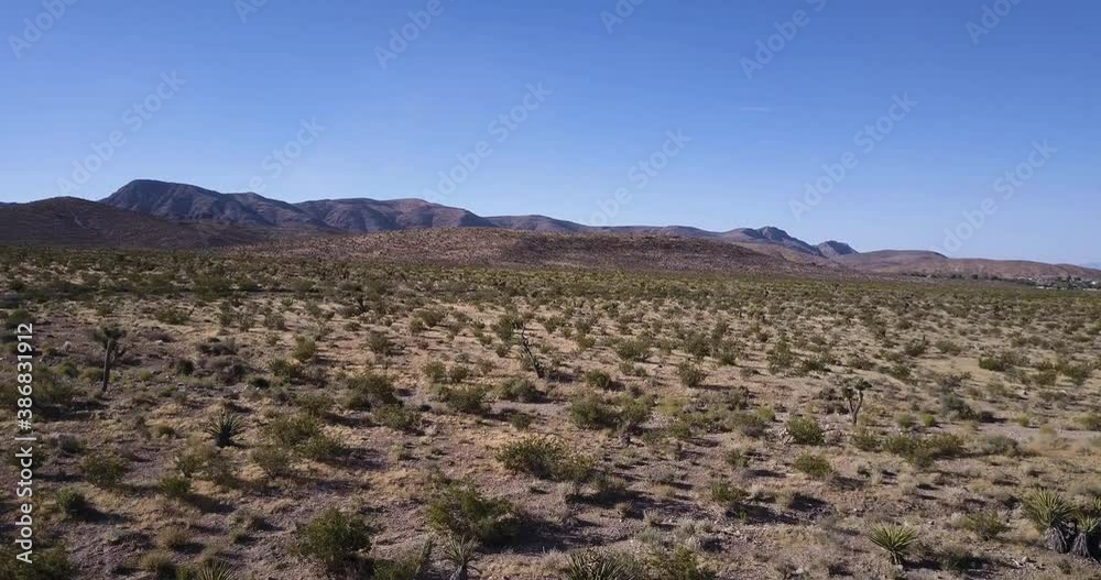 Aerial Drone Shot of Red Desert Mountains. Aerial view of empty Mojave desert landscape between Barstow and Baker in Southern California. Aerial Drone Shot of Red Desert Mountains. Aerial view of empty Mojave desert landscape between Barstow and Baker in Southern California.