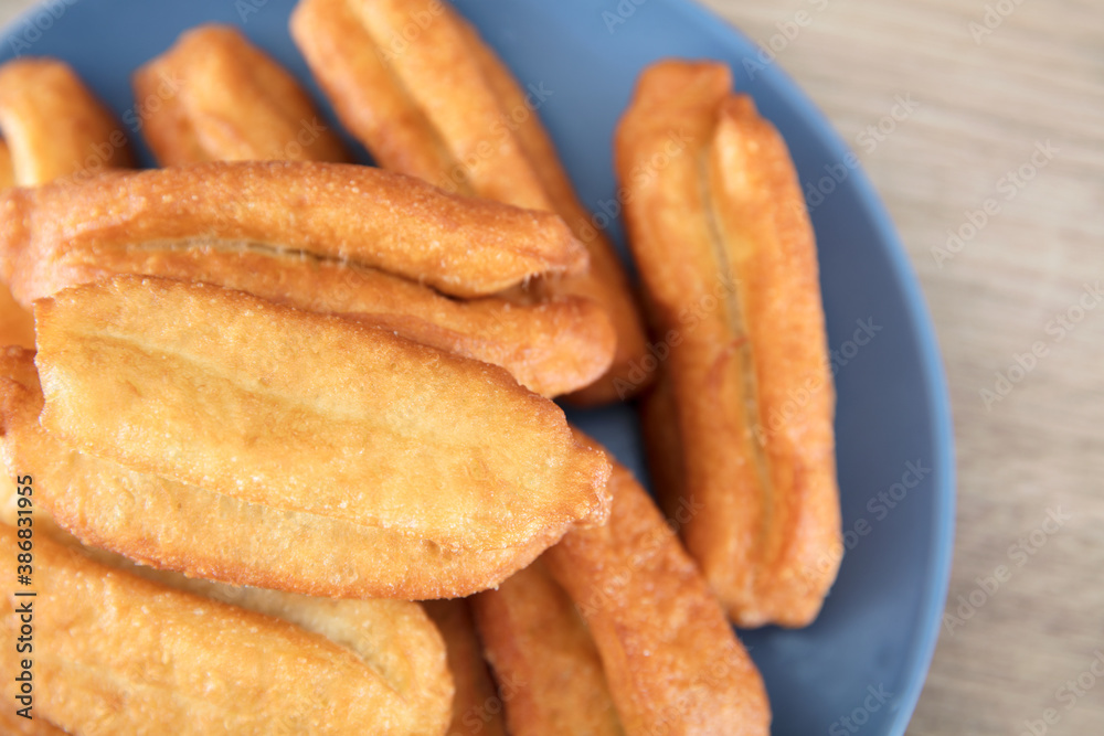 Looking down and shooting a plate of fried dough sticks Looking down and shooting a plate of fried dough sticks