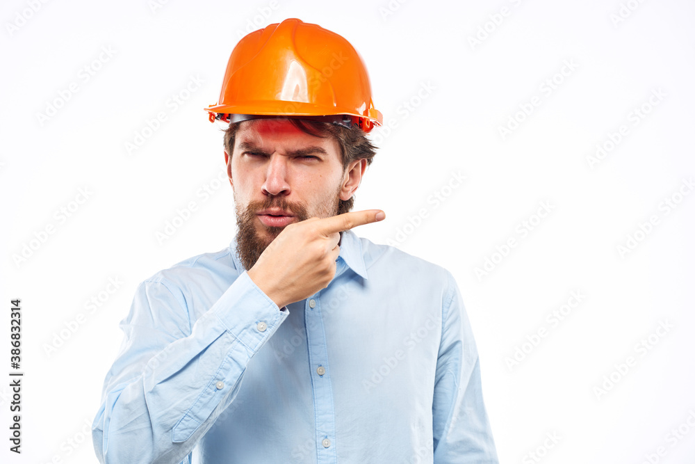 A man gestures with his hands an engineer orange hard hat safety construction A man gestures with his hands an engineer orange hard hat safety construction