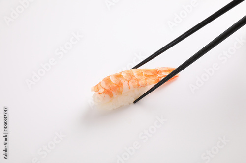 Shrimp sushi with chopsticks Japanese food isolated in white background