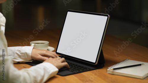Female typing on tablet keyboard include clipping path on table
