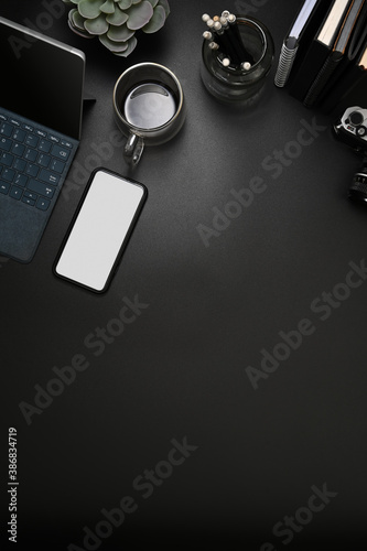Black table with smartphone, tablet, office supplies and copy space, include clipping path