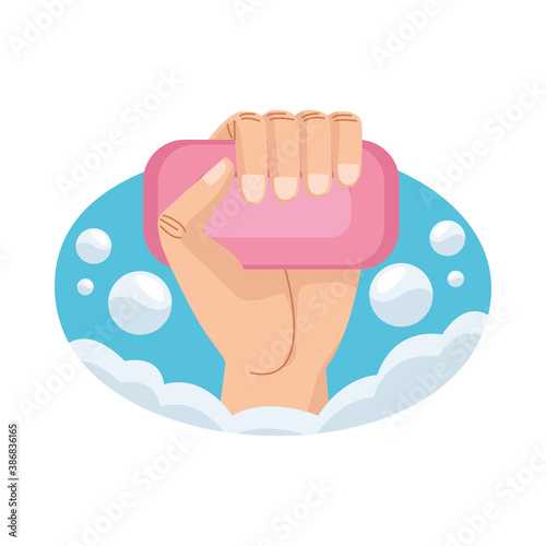 hand with soap bar product and foam