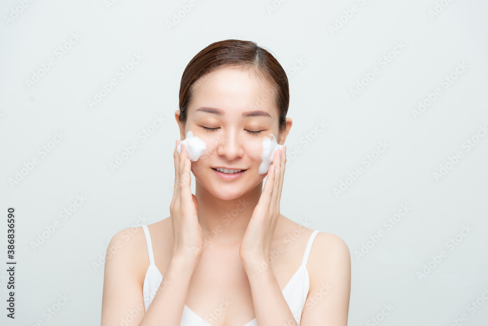 Portrait of cheerful laughing woman applying foam for washing on her face. Portrait of cheerful laughing woman applying foam for washing on her face.