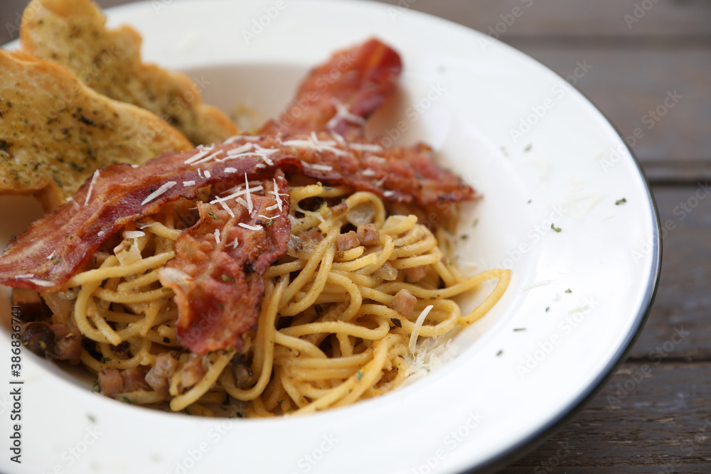 Spaghetti carbonara Spaghetti white sauce with cheese bacon in outdoor restaurant italian food