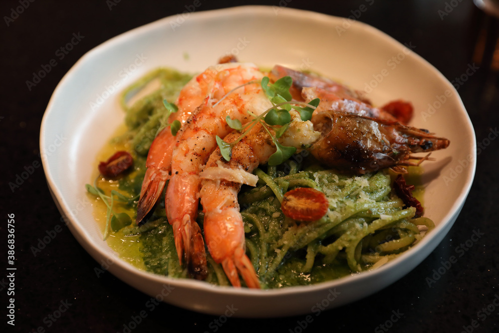 spaghetti pesto sauce with grilled shrimps italian food
