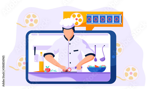 Professional chef slices paprika on a cutting board for the salad. Video recording of a culinary blog on the Internet. A man on a tablet screen teaches to cook different dishes. Online cooking