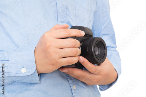 Close-up of photographer holding SLR camera in hand