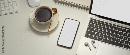 Workspace with smartphone, laptop, coffee cup and accessories, include clipping path