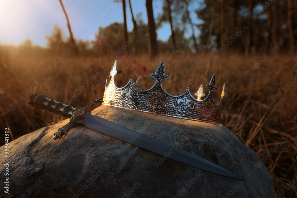 mysterious and magical photo of silver king crown and sword in the