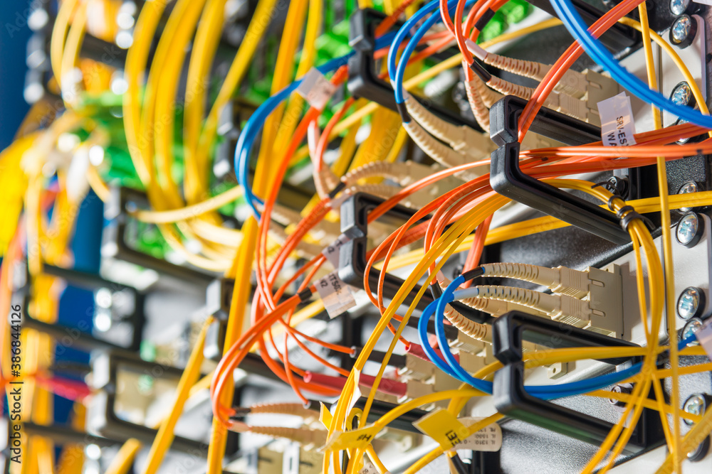 detail of server rack with fiber optic cables attached to front detail of server rack with fiber optic cables attached to front