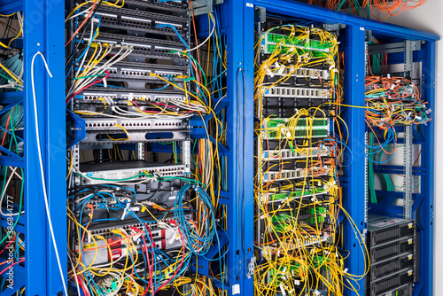 Server rack with fiber optic cables attached to front panel swit