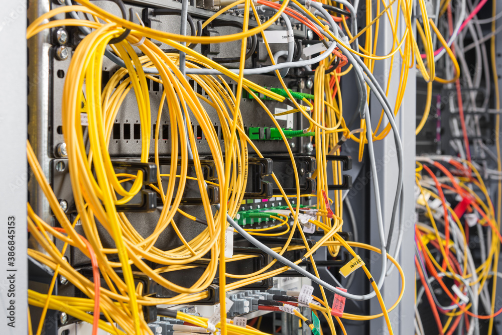 detail of server rack with fiber optic cables attached to front detail of server rack with fiber optic cables attached to front