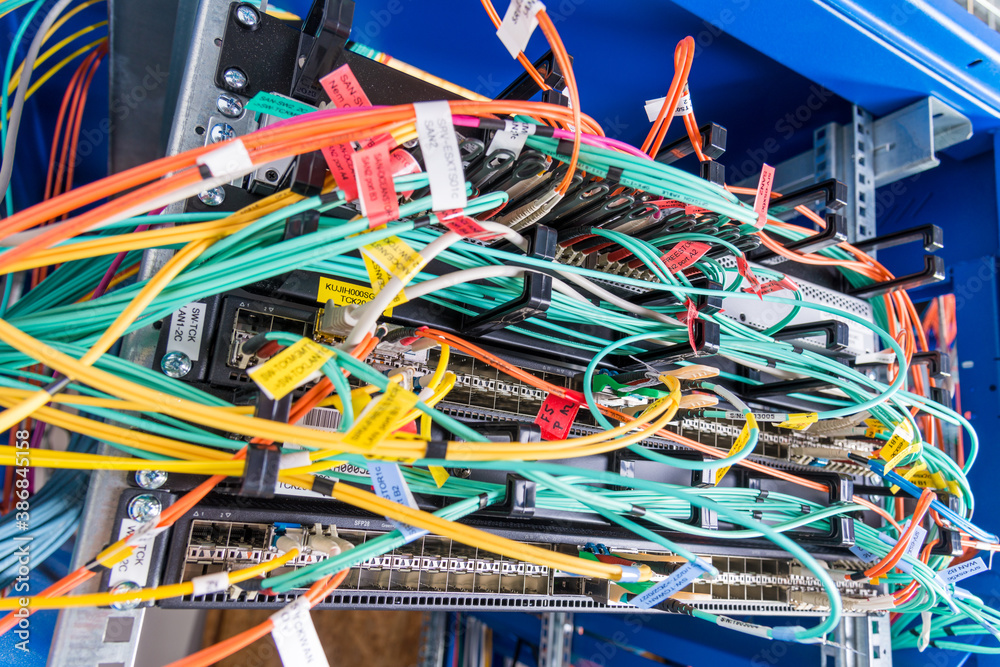 detail of server rack with fiber optic cables attached to front detail of server rack with fiber optic cables attached to front