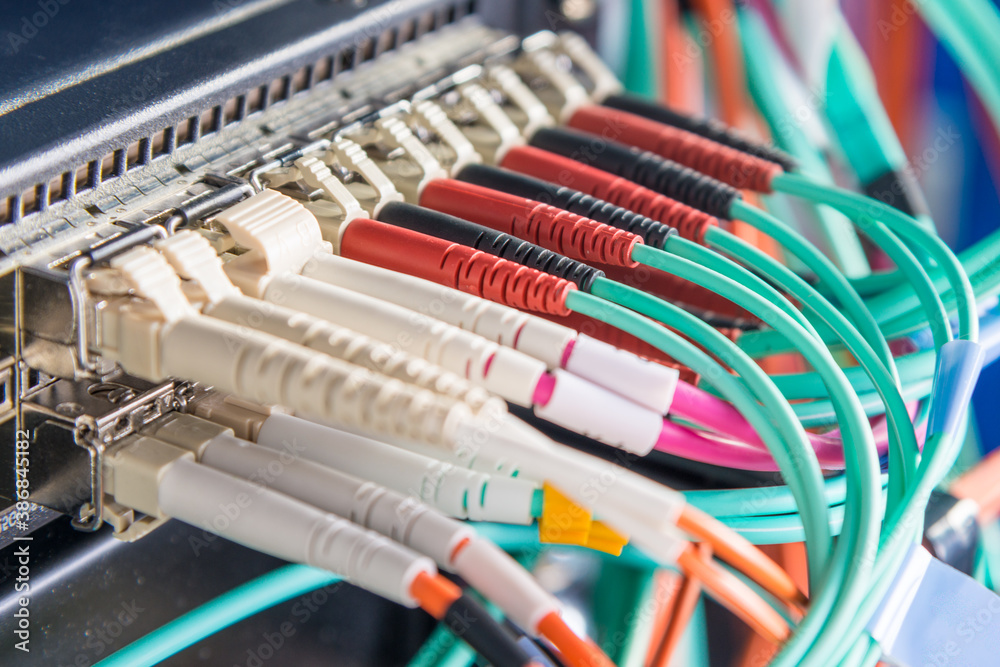 detail of server rack with fiber optic cables attached to front detail of server rack with fiber optic cables attached to front
