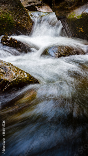 waterfall in the forest. Water ripples over the rocks on waterfall.
