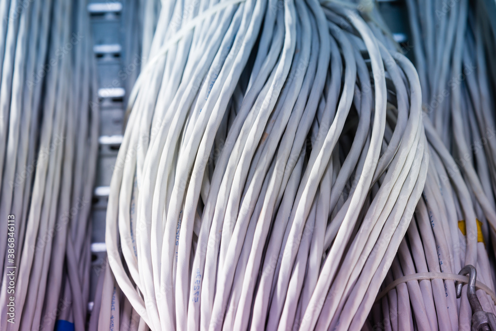 bunch of network cables in wave pattern in server room bunch of network cables in wave pattern in server room