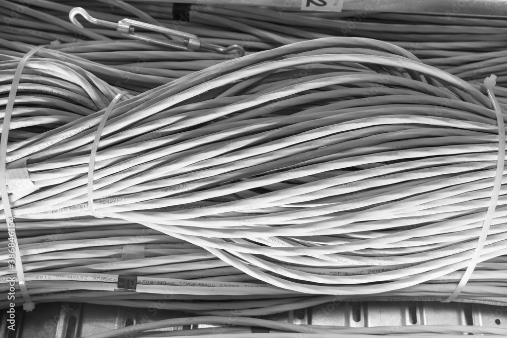 bunch of network cables in wave pattern in server room bunch of network cables in wave pattern in server room