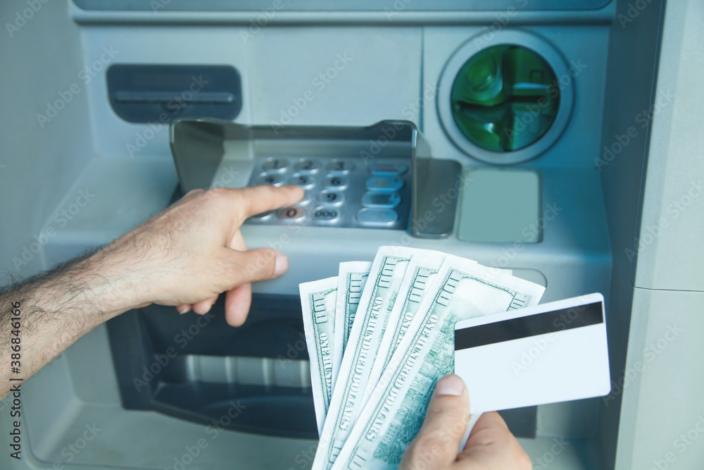Hand holding dollars and credit card withdrawn from ATM. Hand holding dollars and credit card withdrawn from ATM.