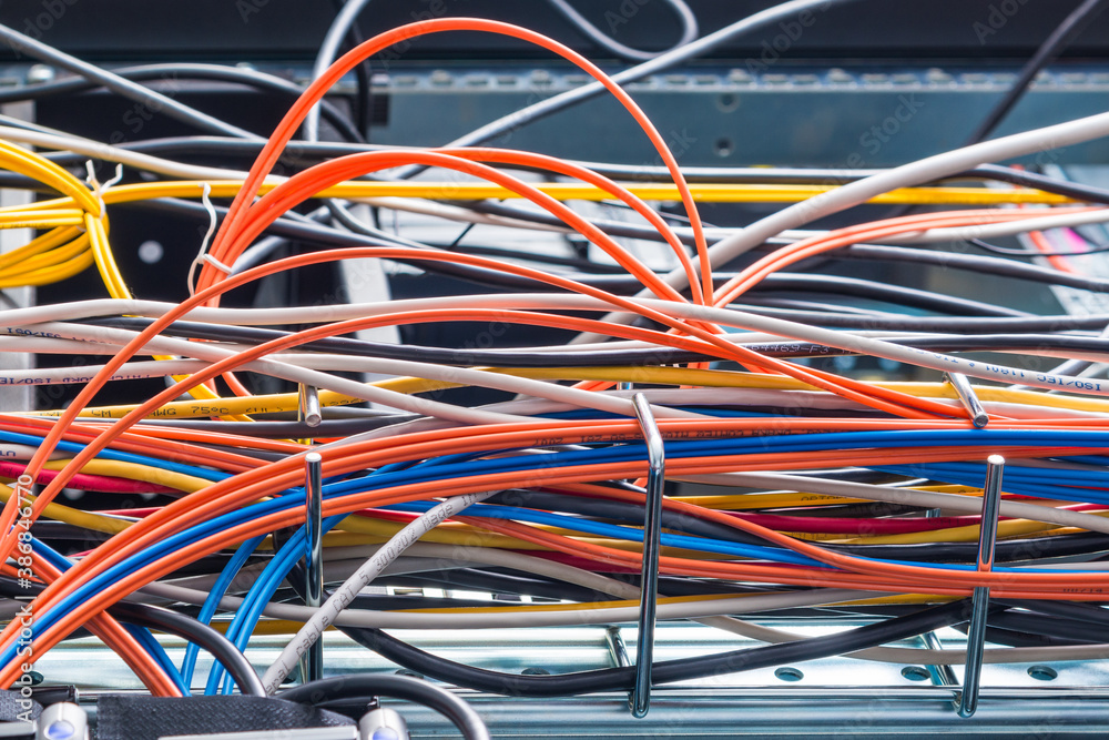 bunch of network cables in wave pattern leading across server ro bunch of network cables in wave pattern leading across server ro