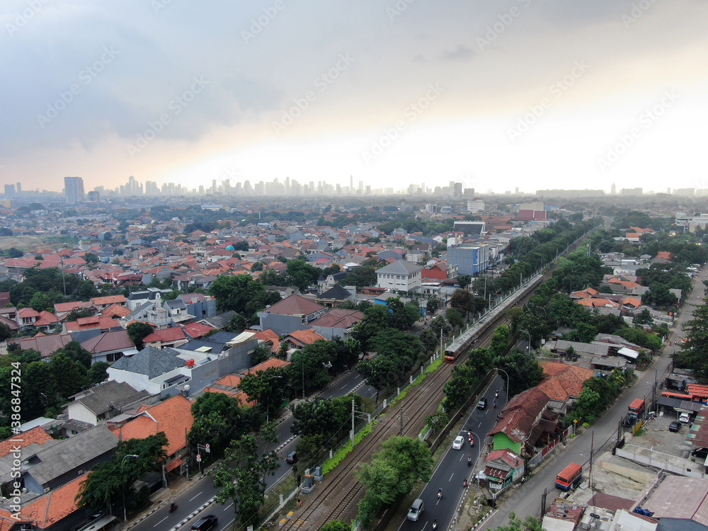 Aerial drone view of KRL commuter line Jabodetabek JR205 electric train near Pasar Minggu, Jakarta, Indonesia