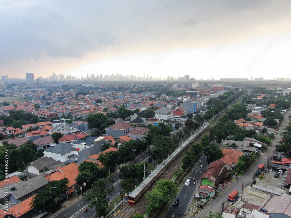 Aerial drone view of KRL commuter line Jabodetabek JR205 electric train near Pasar Minggu, Jakarta, Indonesia