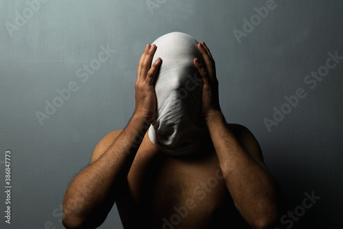 A sinister person's face covered in white cloth depicting ghost photo