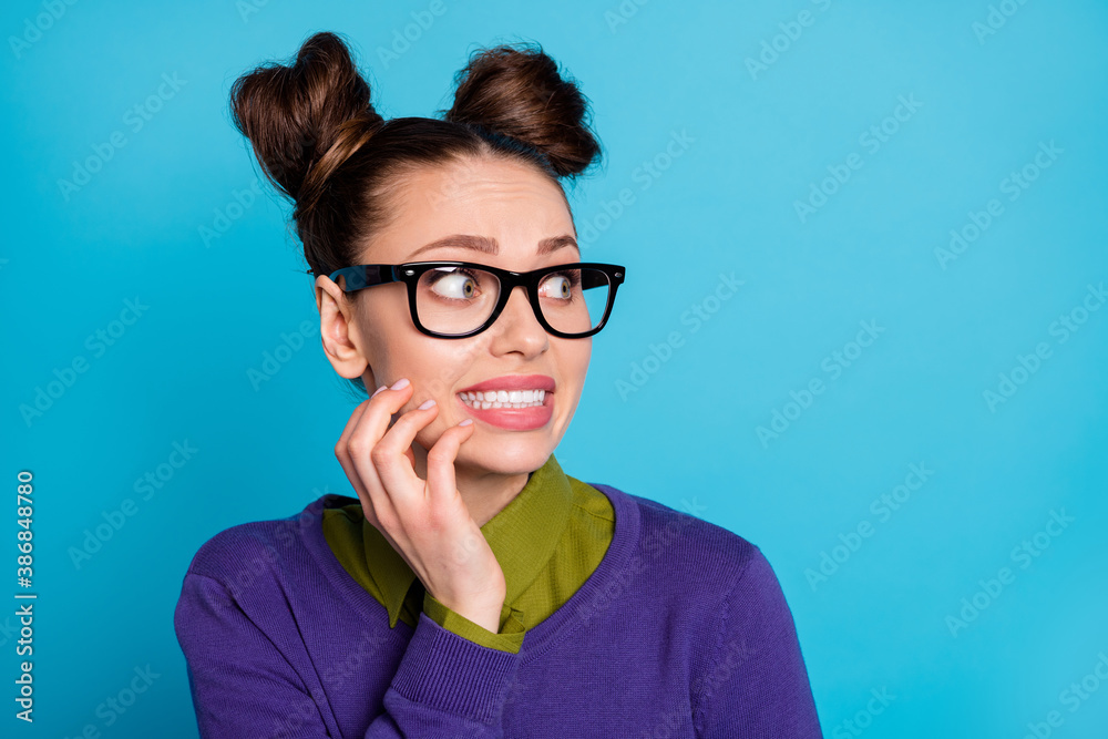 Closeup photo of attractive crazy terrified student lady two funny buns look side empty space did wrong thing made mistake wear shirt collar violet sweater isolated blue color background