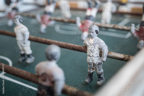 Table football player close up. Worn out game. Miniature soccer player.