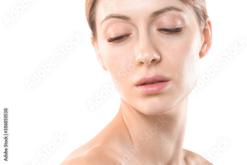 Beautiful female face with closed eyes and hair up, close up. Caucasian woman portrait with natural makeup, isolated on white.