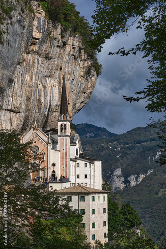 The unique Sanctuary Madonna della Corona church in the rock. The sanctuary is high in the cliffs of Italy. View of the church on a steep cliff. Italian church at high altitude in the Alps. photo