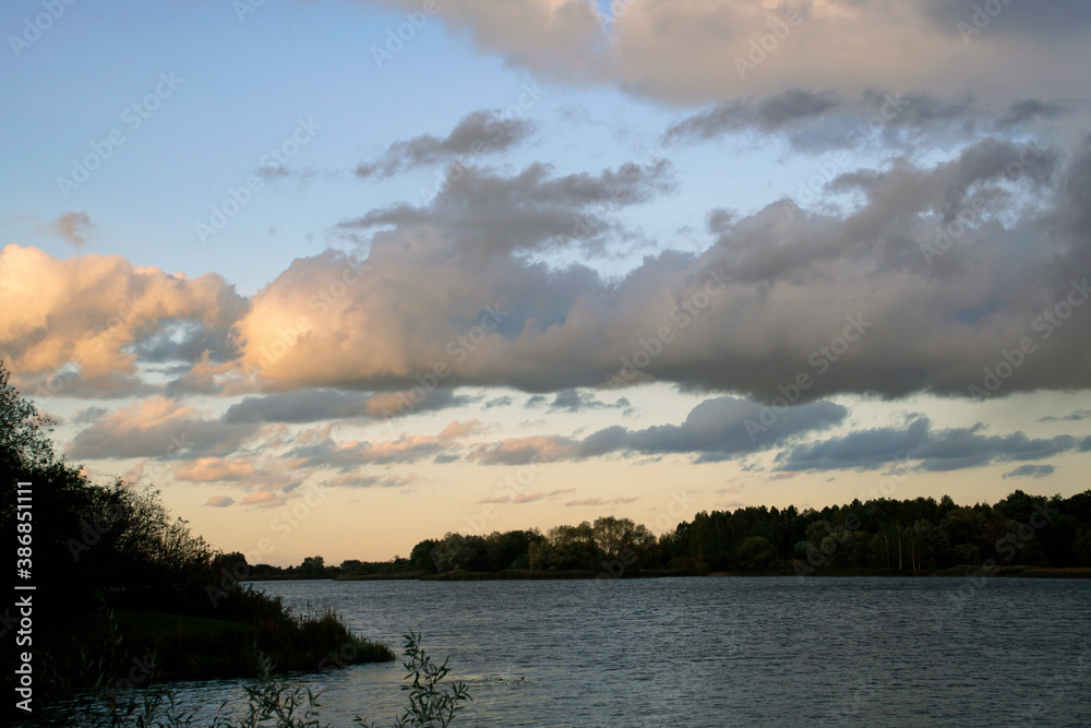  Autumn landscape. Horizontal shot. Beautiful view. Autumn evening at sunset. Sky and clouds. Lake.