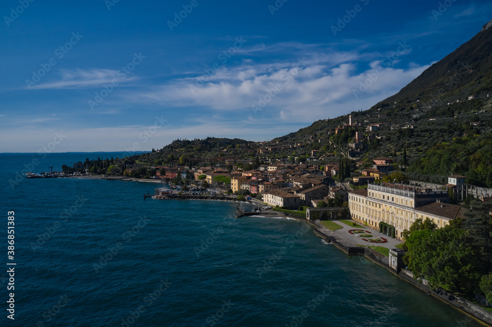 Ancient villa on Lake Garda in the background Alps and blue sky. Panoramic view of the sights on Lake Garda Italy. Aerial view of architecture on Lake Garda.