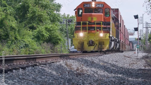 Low angle view of a freight train passing by in slow motion. photo