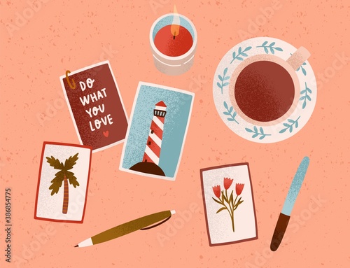 Postcard collecting. Cozy hygge home composition with motivational cards. Desk with a candle, cup of tea or coffee, pictures and pen. Colorful flat vector cartoon top view illustration