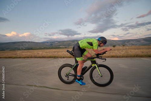 Fototapeta Naklejka Na Ścianę i Meble -  triathlon athlete riding a bike